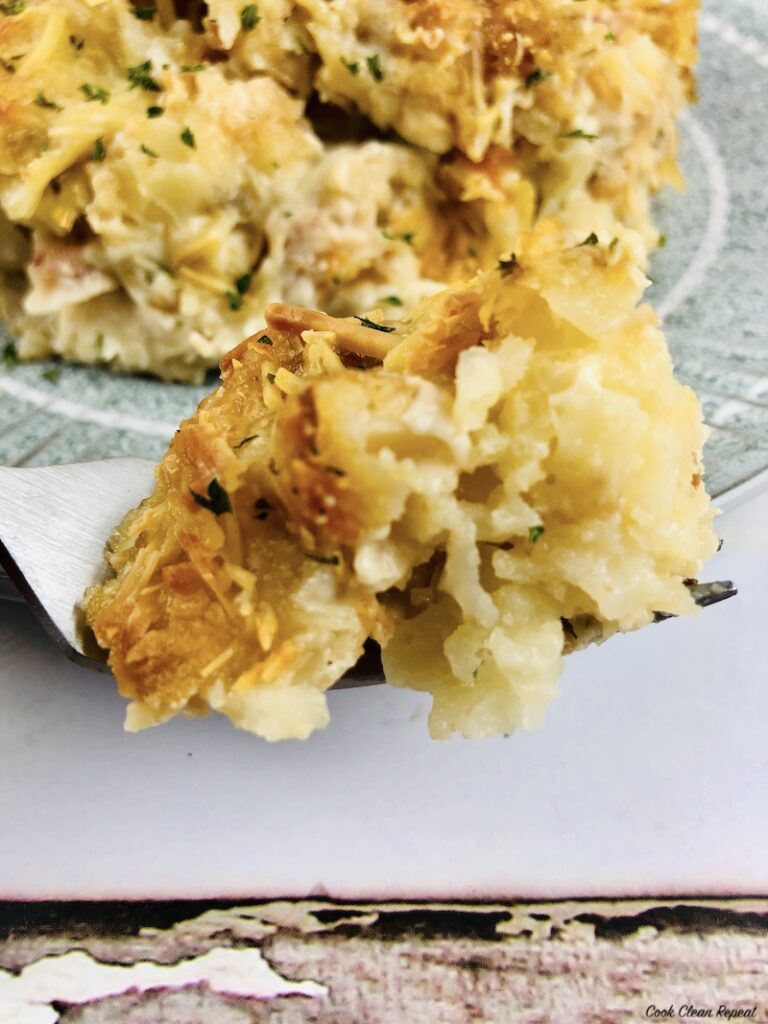 bite of cheesy tater tot casserole on a fork