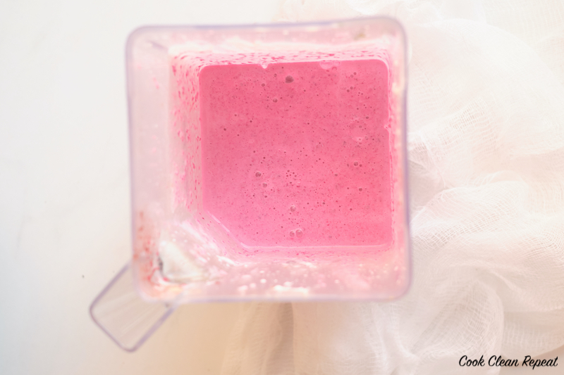 a view of the finished strawberry banana smoothie recipe in the blender. 