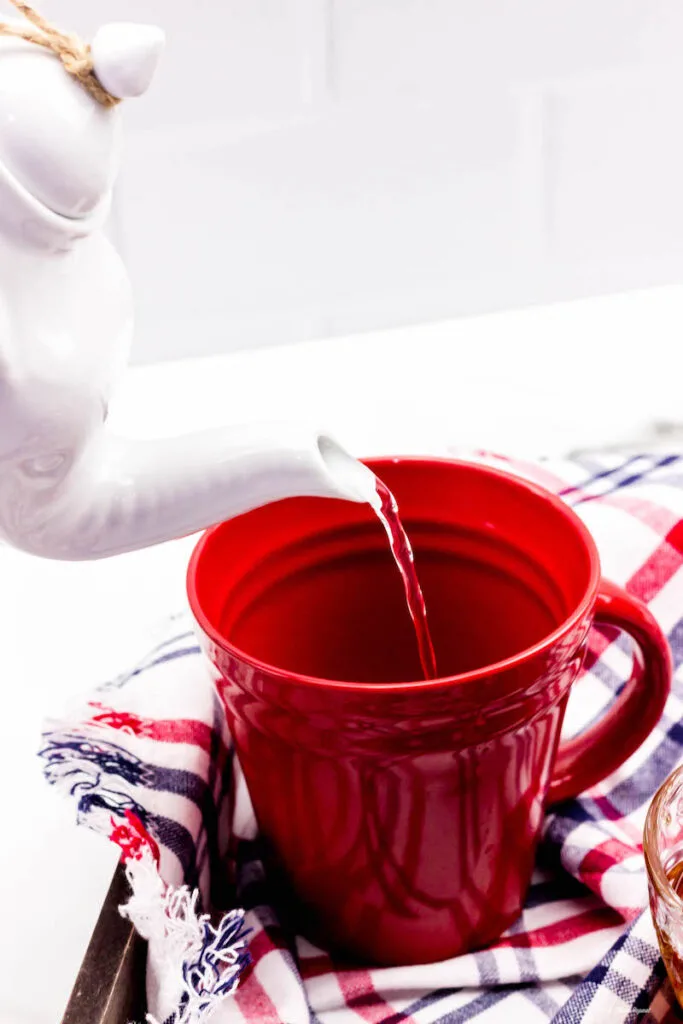 adding hot water to a mug