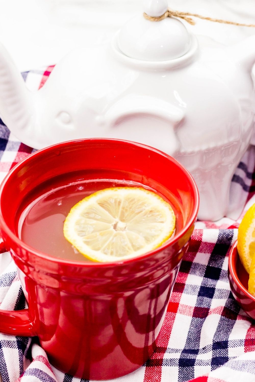 a cup of hot water and tea with a lemon