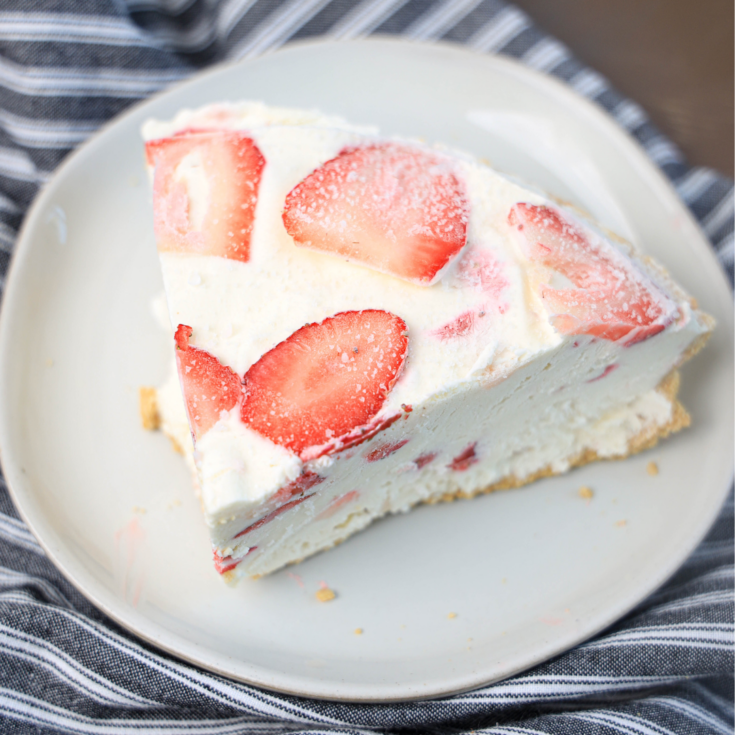 featured image showing slice of strawberry cheesecake ice cream pie ready to eat