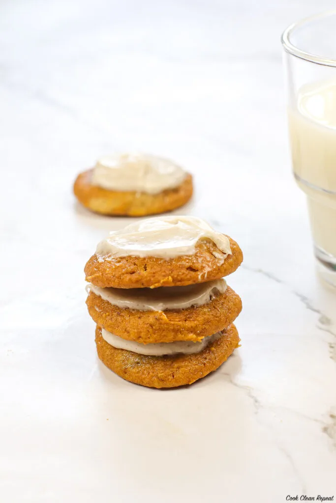 a stack of the finished iced pumpkin cookies. 