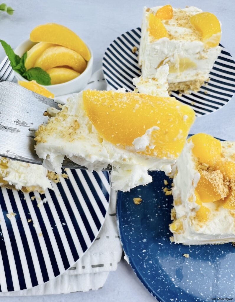 bite of no bake peach cheesecake on a fork ready to eat
