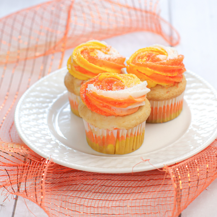 featured image showing the finished candy corn cupcakes on a plate ready to serve.