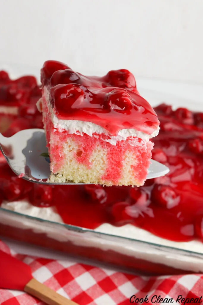 slice of cherry cheesecake poke cake ready to serve. 