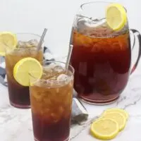 Sweet tea in a pitcher and two glasses with lemons