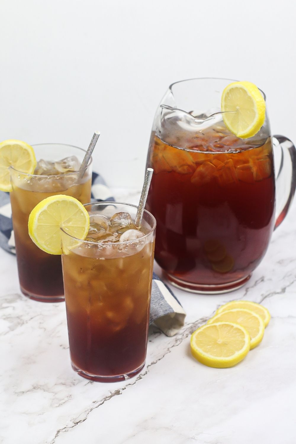 Sweet tea in a pitcher and two glasses with lemons
