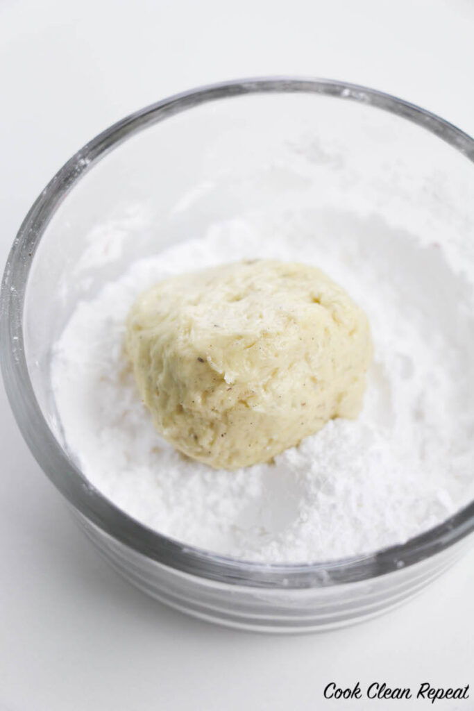 dough ball in the powdered sugar to be coated