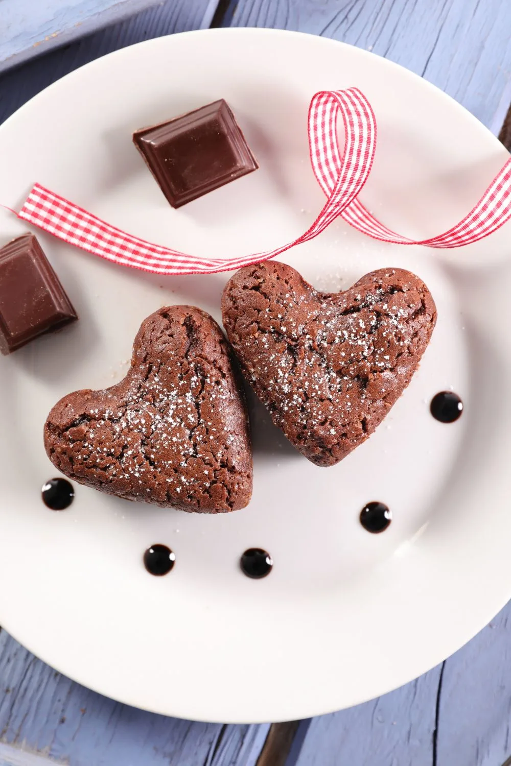 two brownies in the shape of hearts sitting on a plate