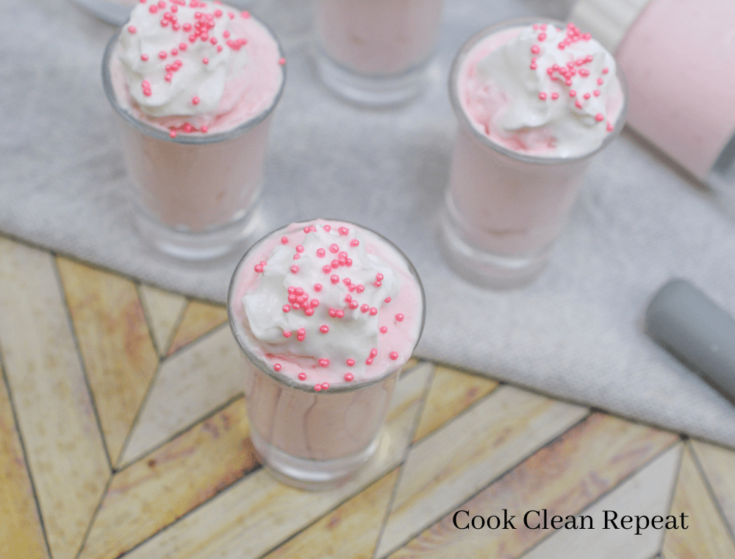 strawberry cheesecake dessert with whipped cream and sprinkles