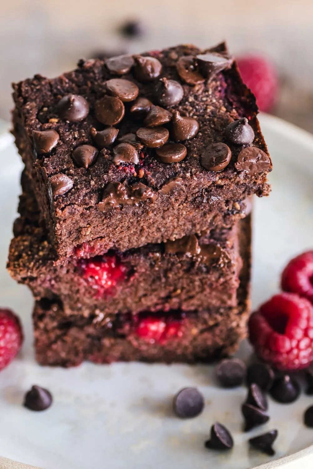 stack of three brownies with chocolate chips and raspberries
