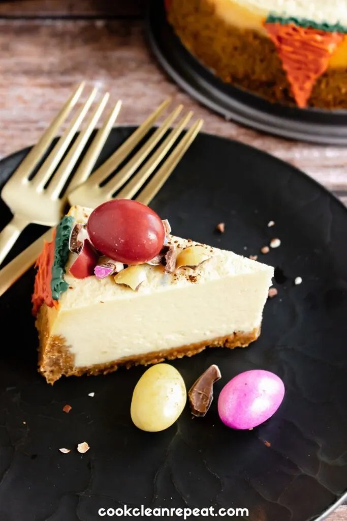 Slice of Easter cheesecake with chocolate eggs and forks beside it