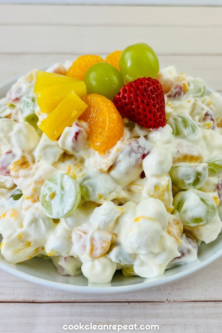 Fruit Salad with Pudding topped with fresh strawberries, pineapple, mandarin, and grapes