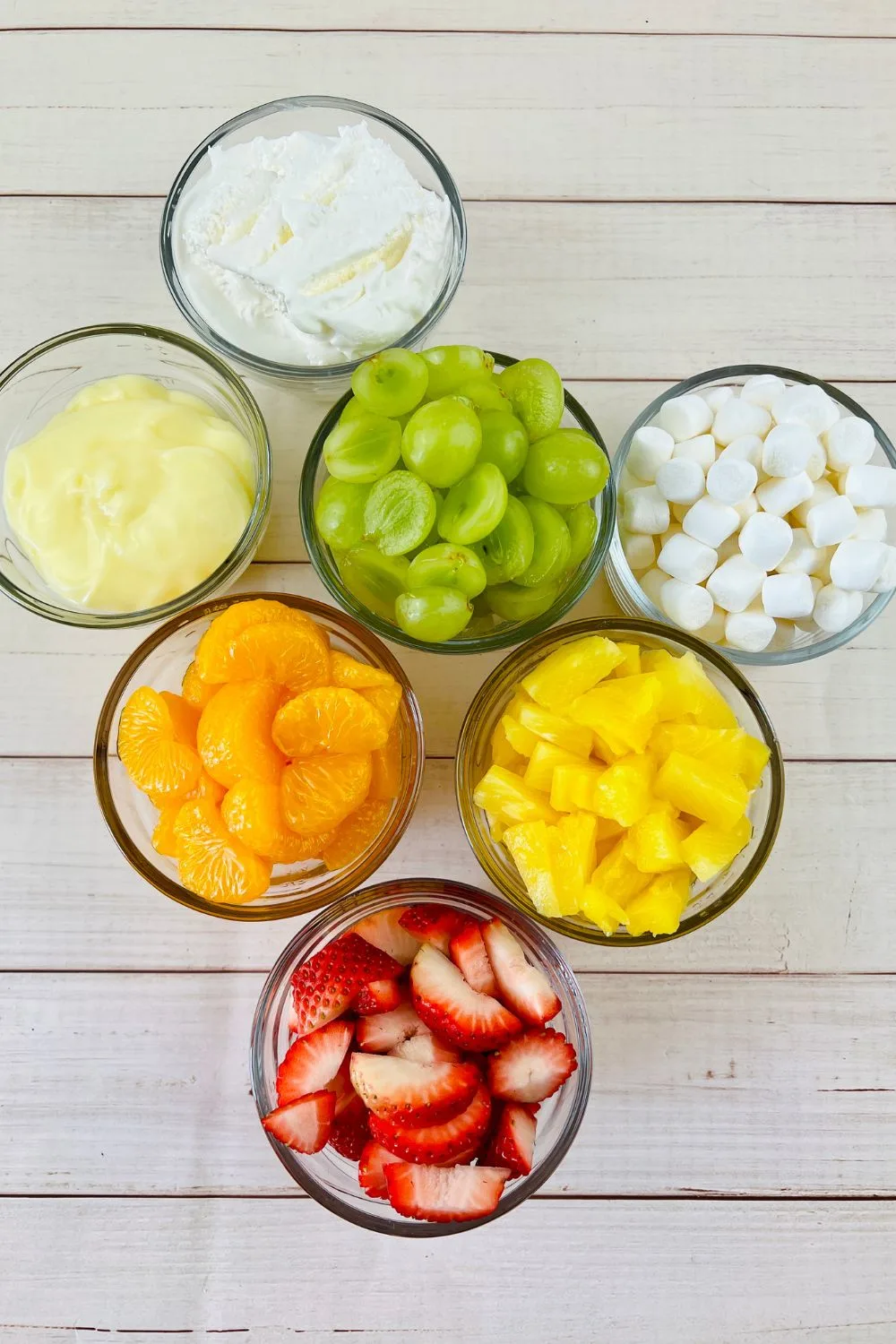 all of the ingredients needed for this fruit salad with putting recipe