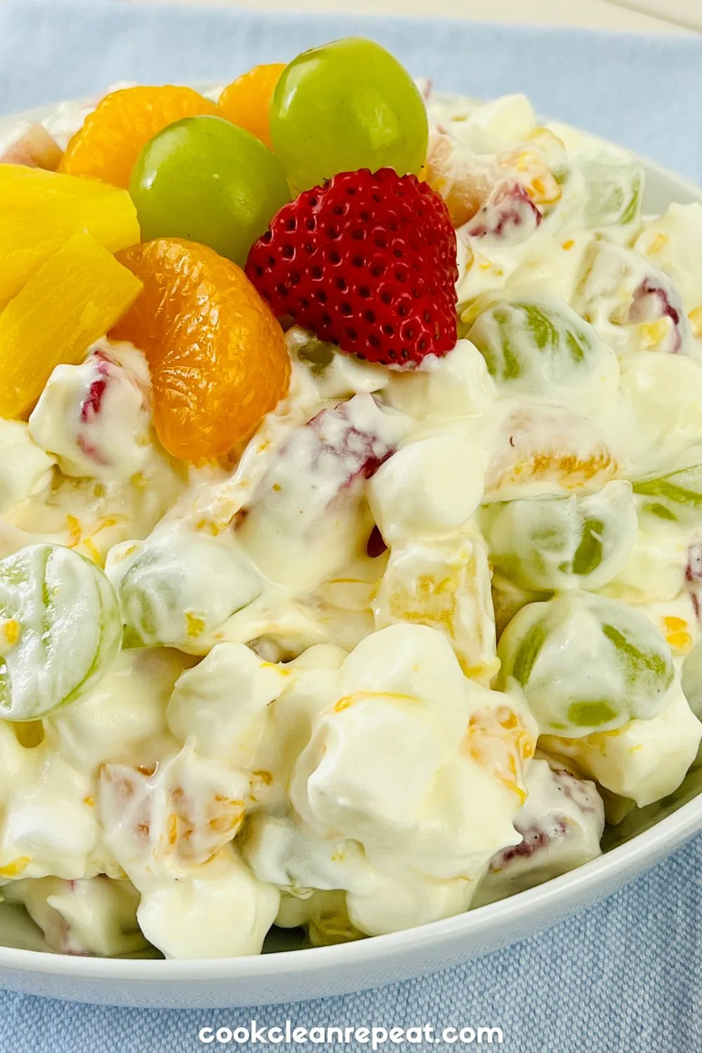 Fruit Salad with Pudding topped with fresh strawberries, pineapple, mandarin, and grapes
