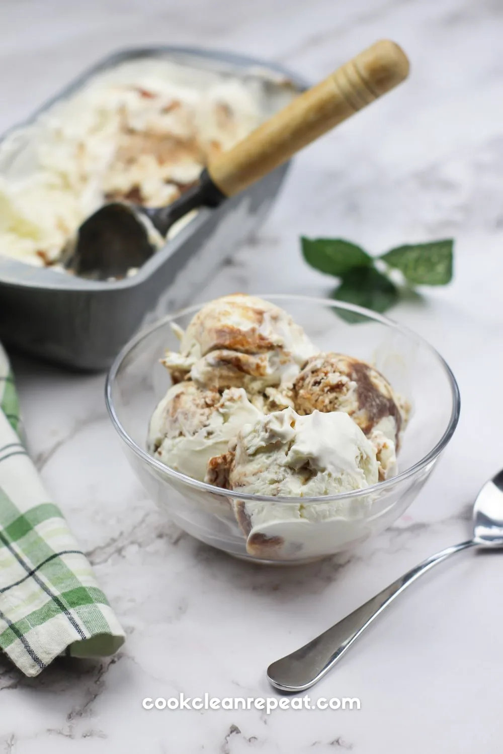a bowl of apple butter ice cream with the pan of ice cream in the background