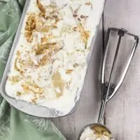apple pie ice cream up close in a pan beside a used scoop