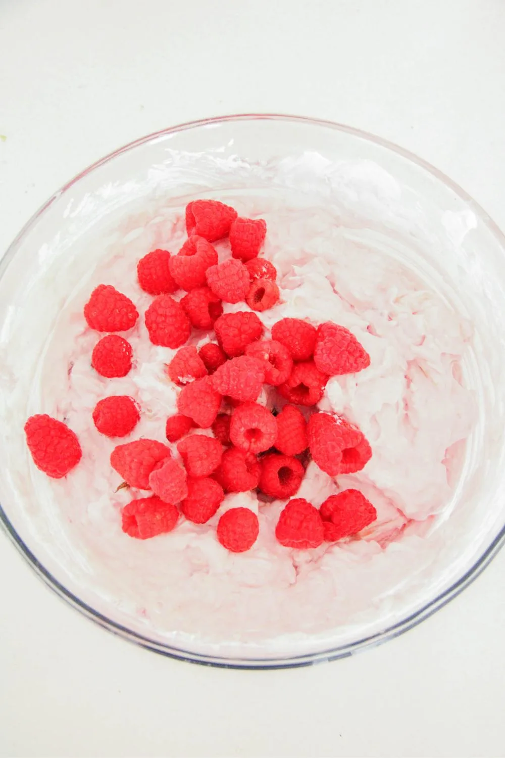 cherry fluff salad topped with raspberries