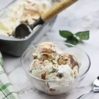 a bowl of apple butter ice cream with the pan of ice cream in the background