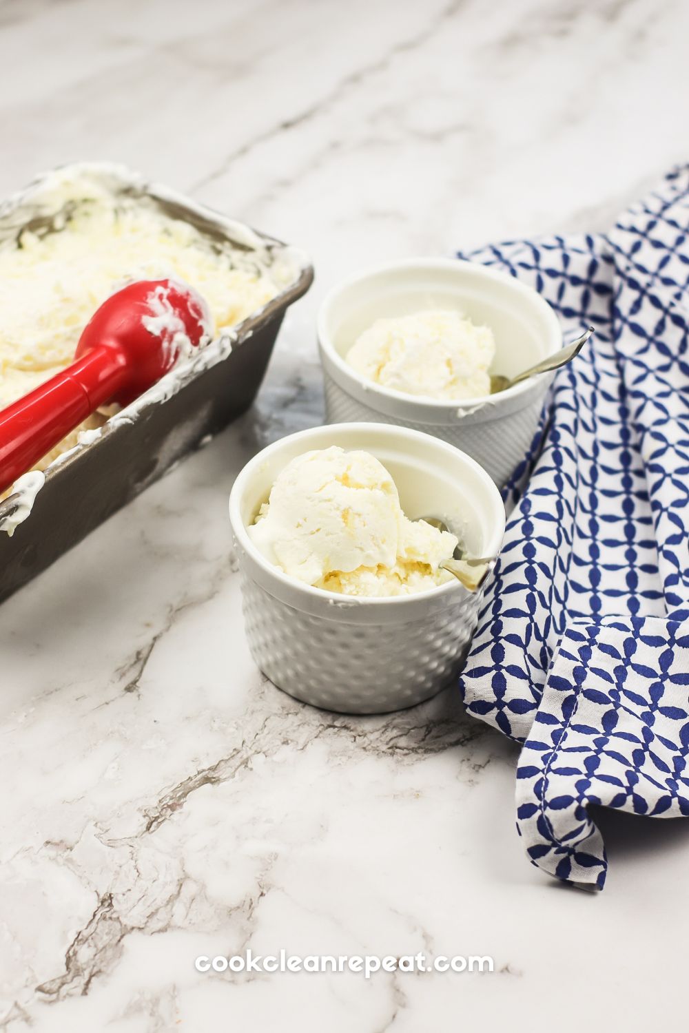 two bowls of pineapple ice cream with the loaf pan and scoop beside them