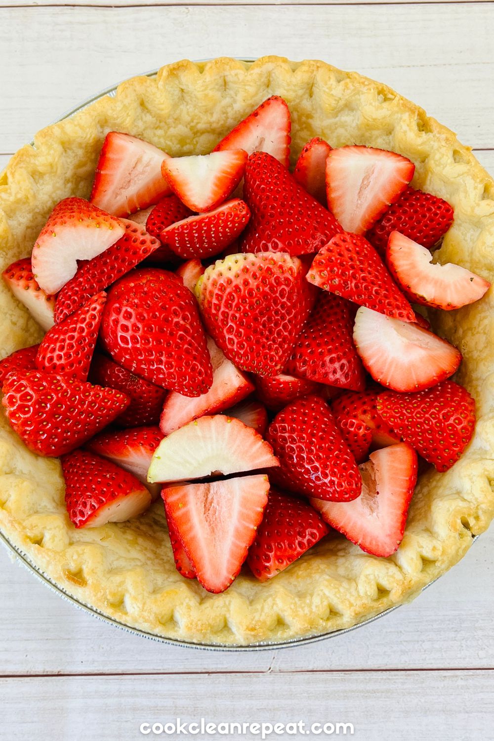 fresh cut strawberries in a pie crust