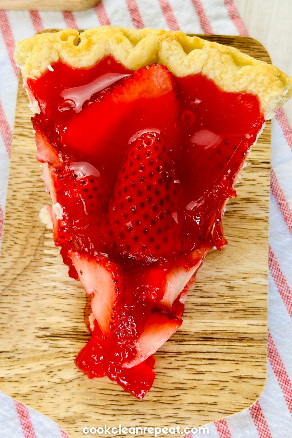 an above view of a slice of strawberry pie with jello on top