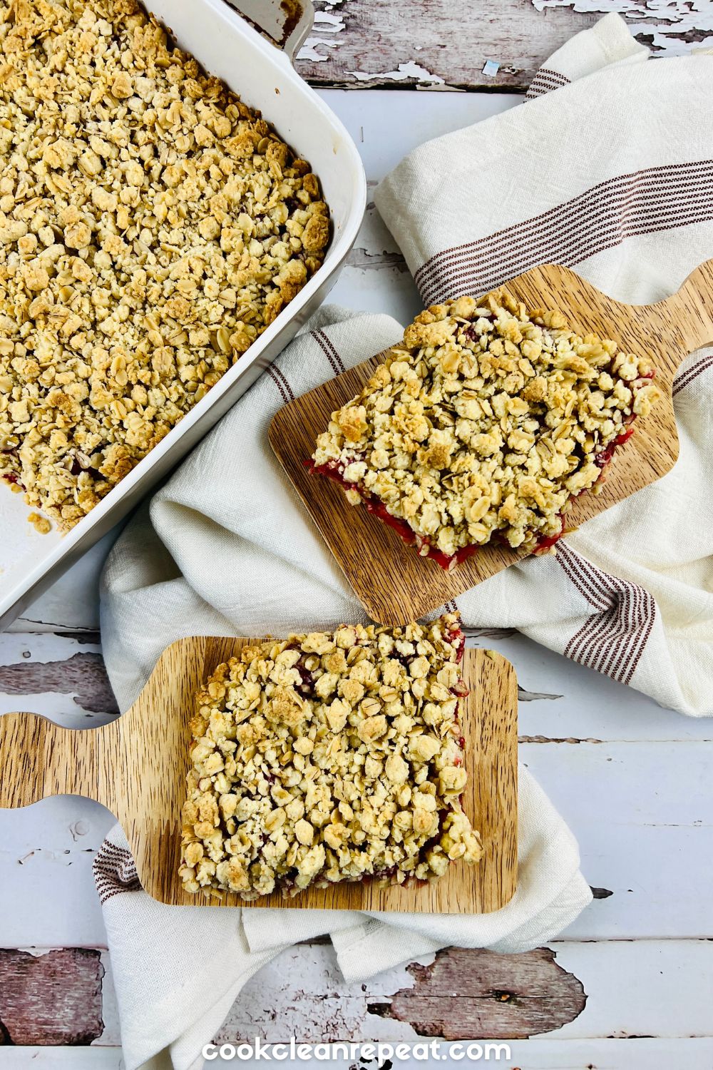 two slices of cherry bars on a table beside the baking dish
