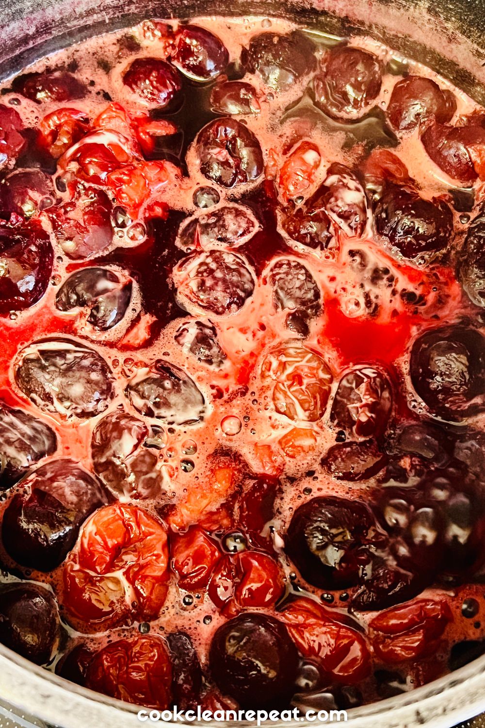 up close photo of cherries cooking on a stove