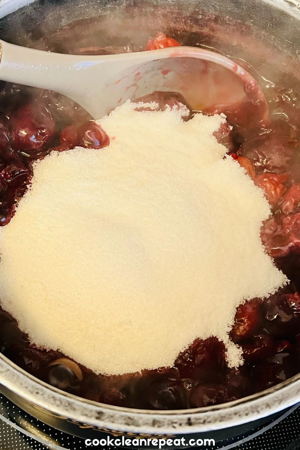 sugar being added to the cherry filling