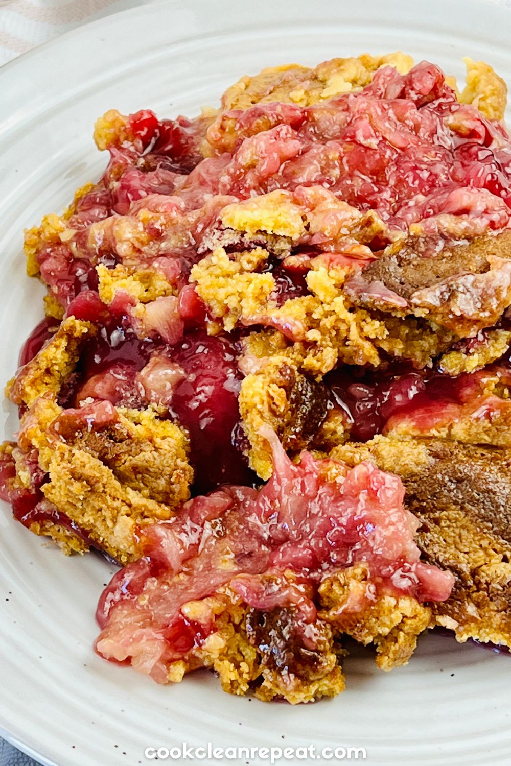 a serving of Cherry Pineapple Dump Cake on a plate showing the texture