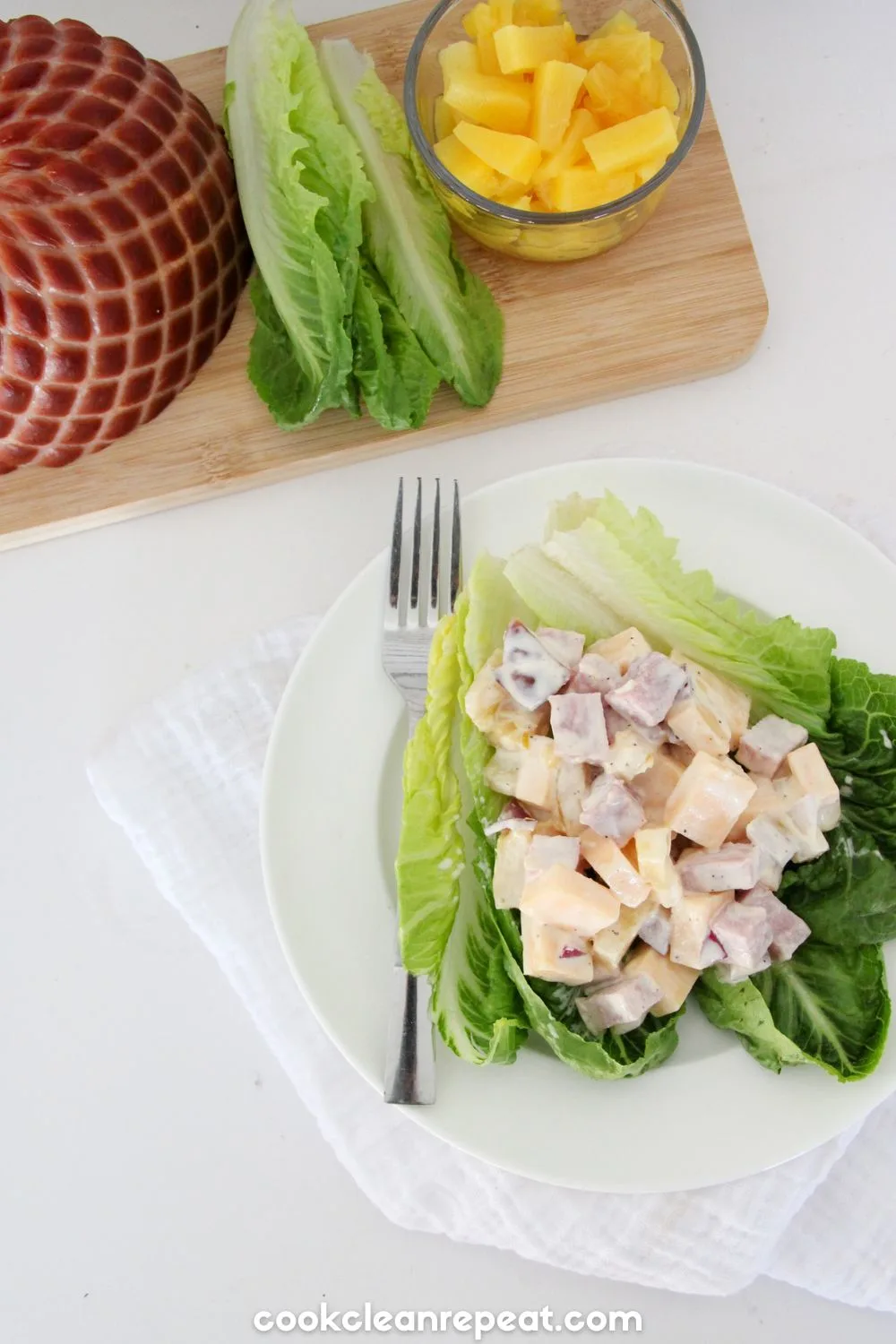 Pineapple Ham Salad on a lettuce leave with ingredients in the background