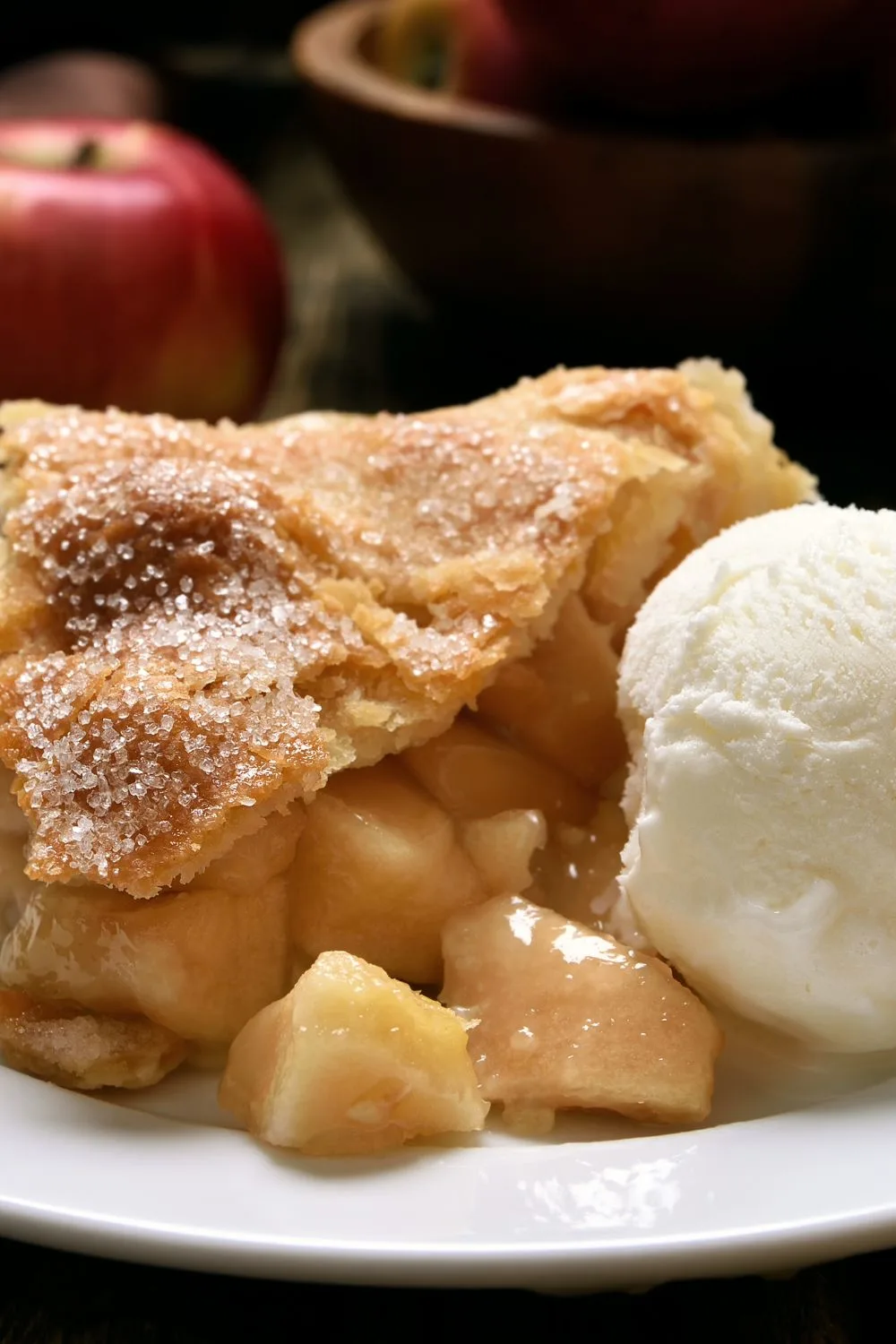 a slice of apple pie next to a scoop of ice cream