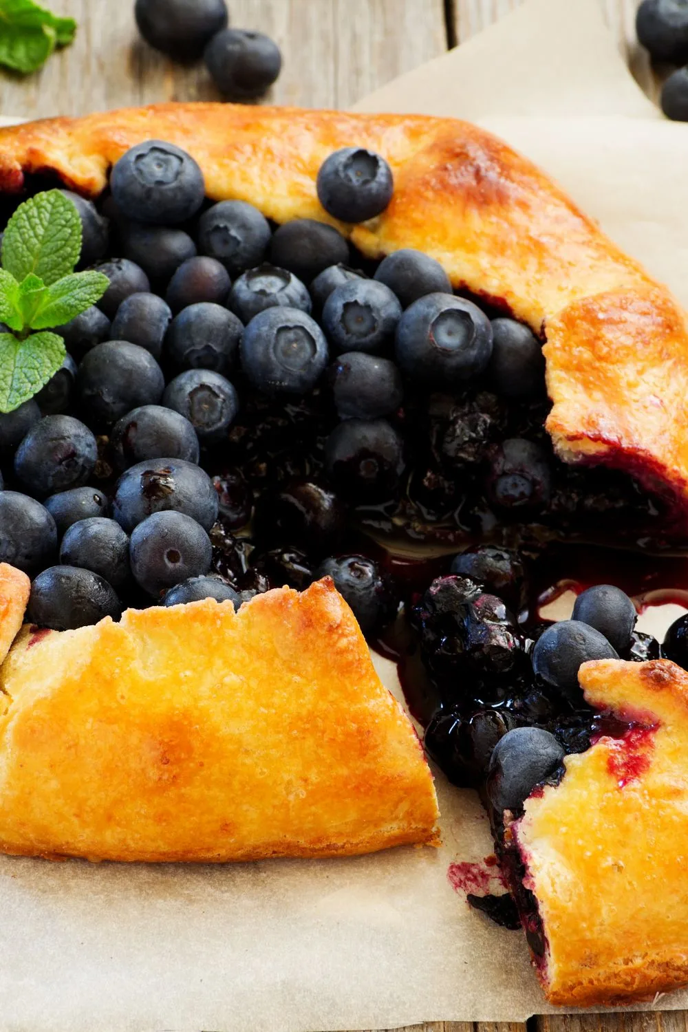 an up close view of a pastry filled up with blueberries and blueberry filling