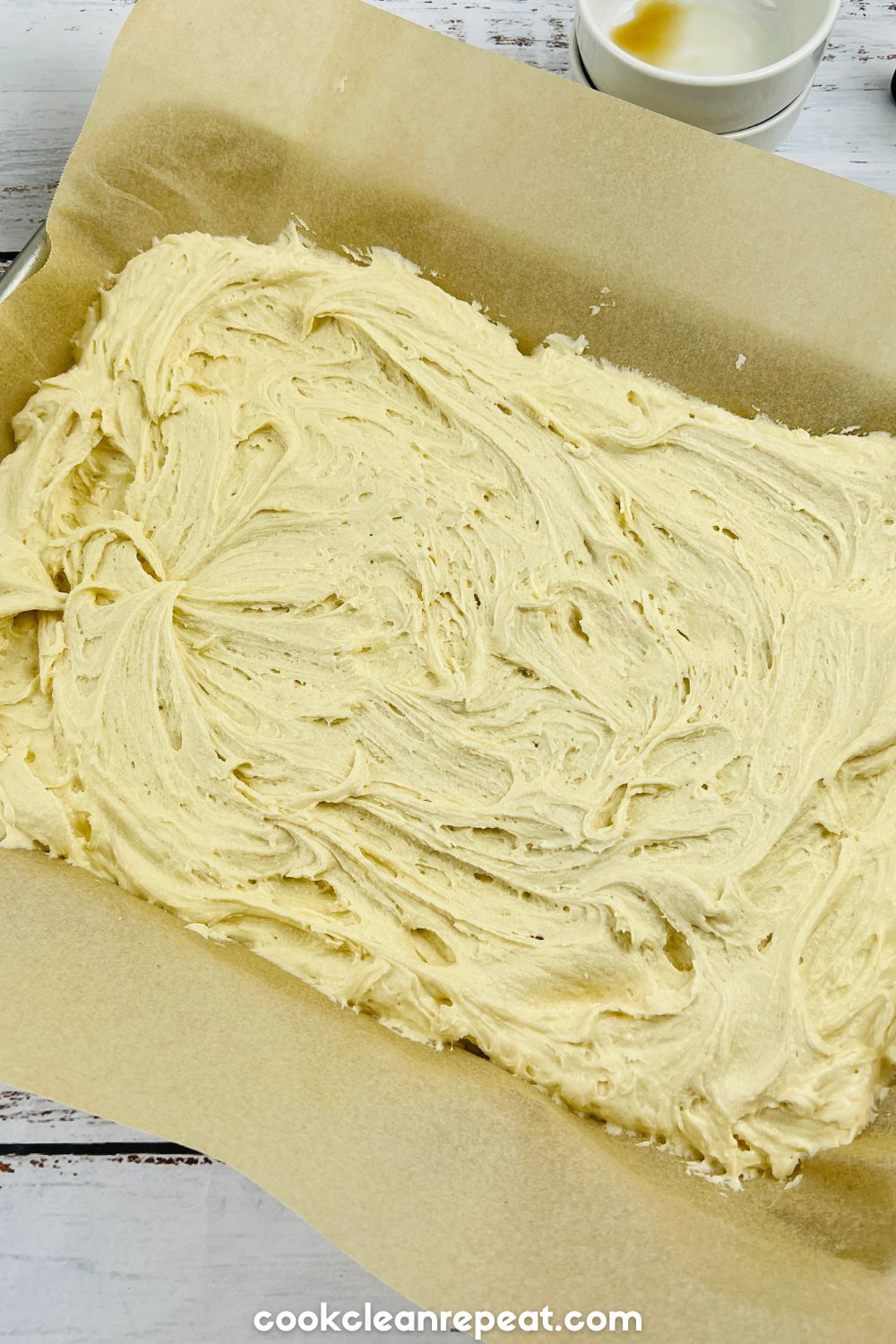 the raw dough in a baking pan