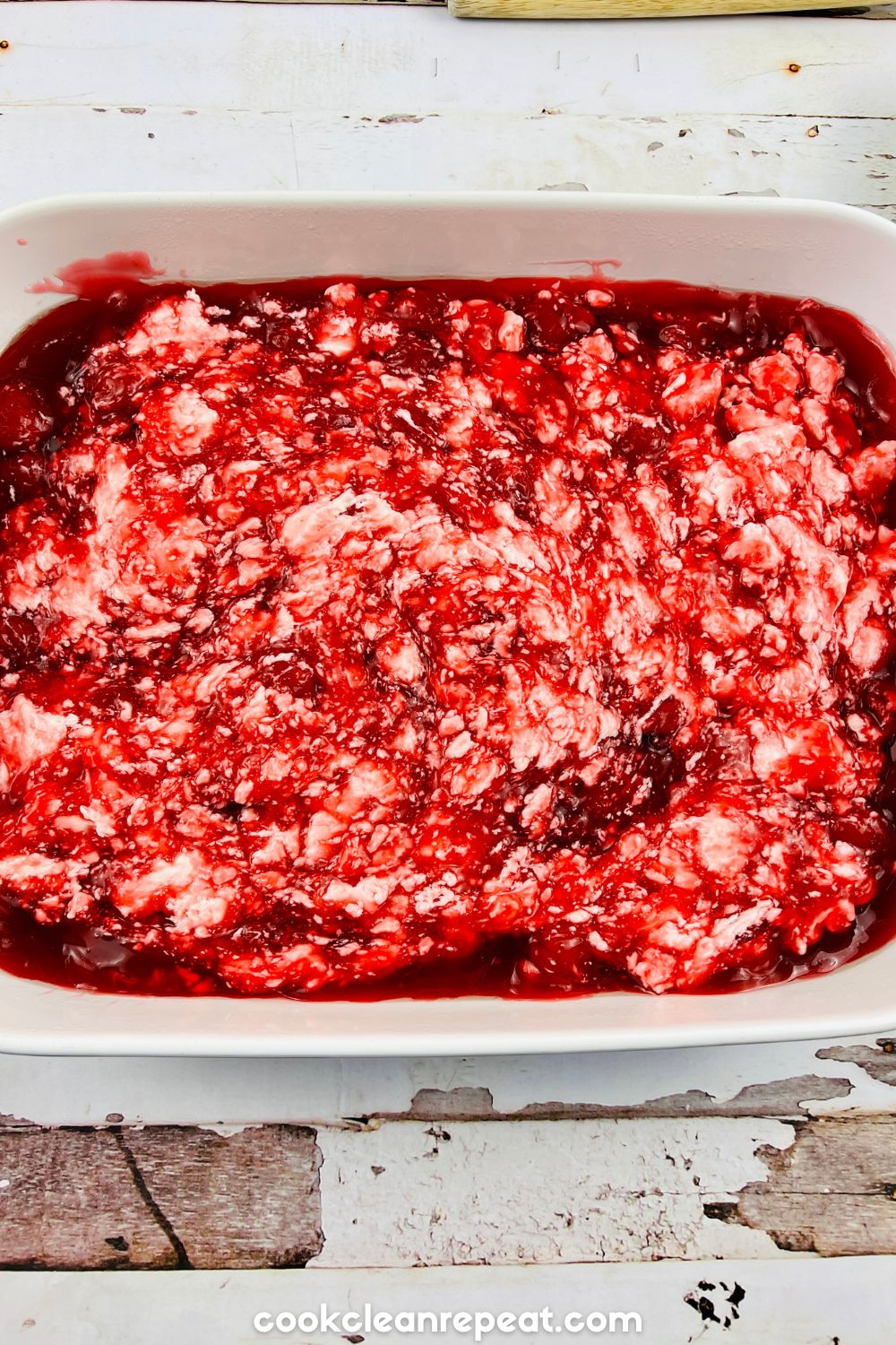 the baking dish with the mixing of cherry filling and cream cheese
