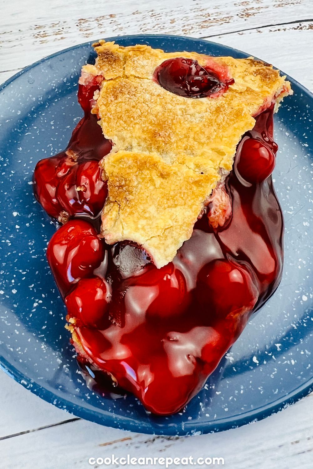 slice of cherry pie on a blue plate
