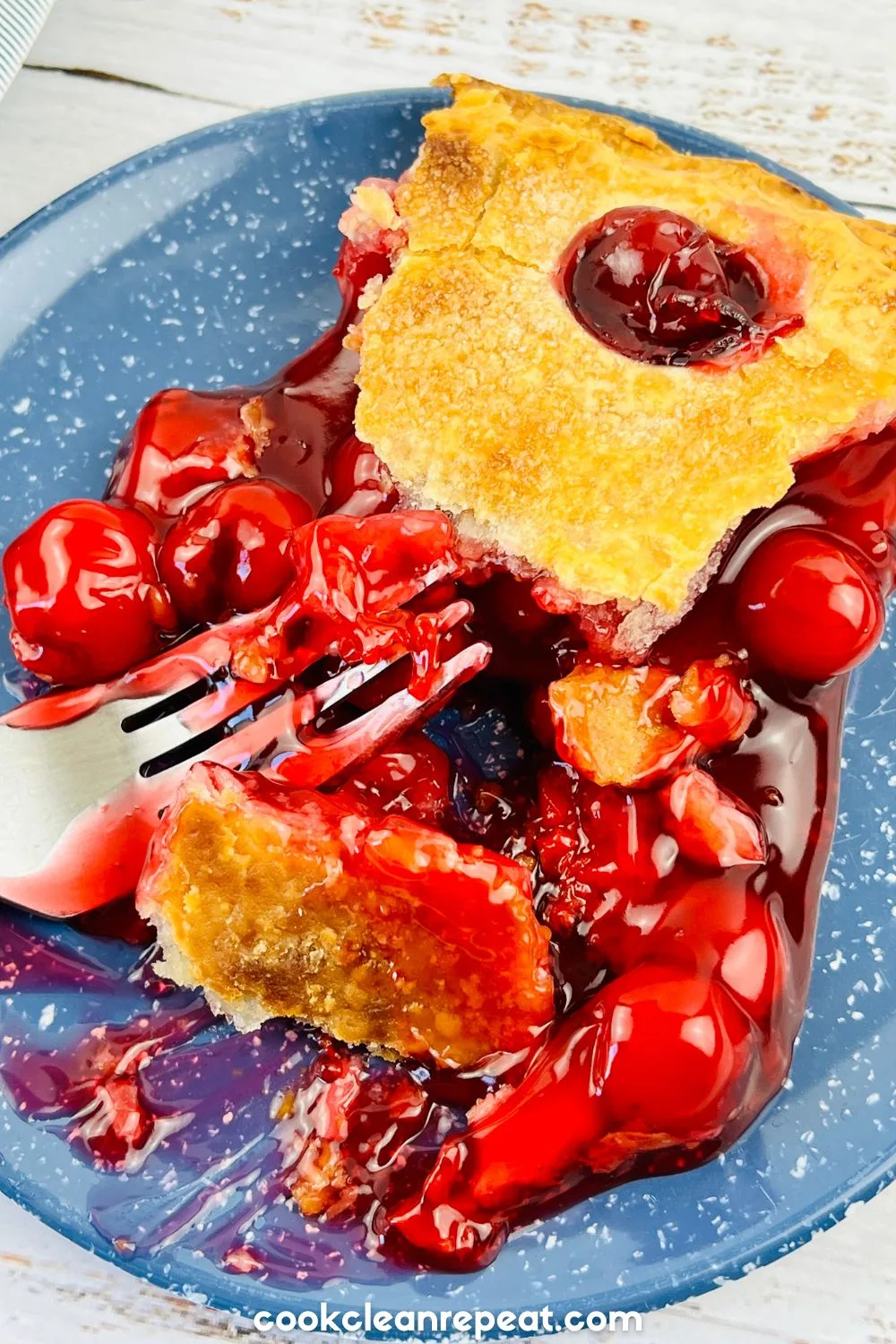 slice of cherry pie on a blue plate
