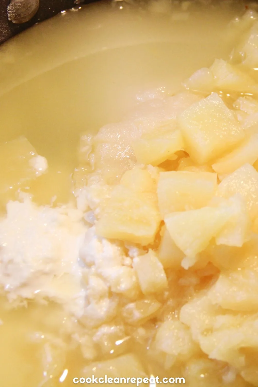 a close up of mixing the ingredients for pineapple pie filling