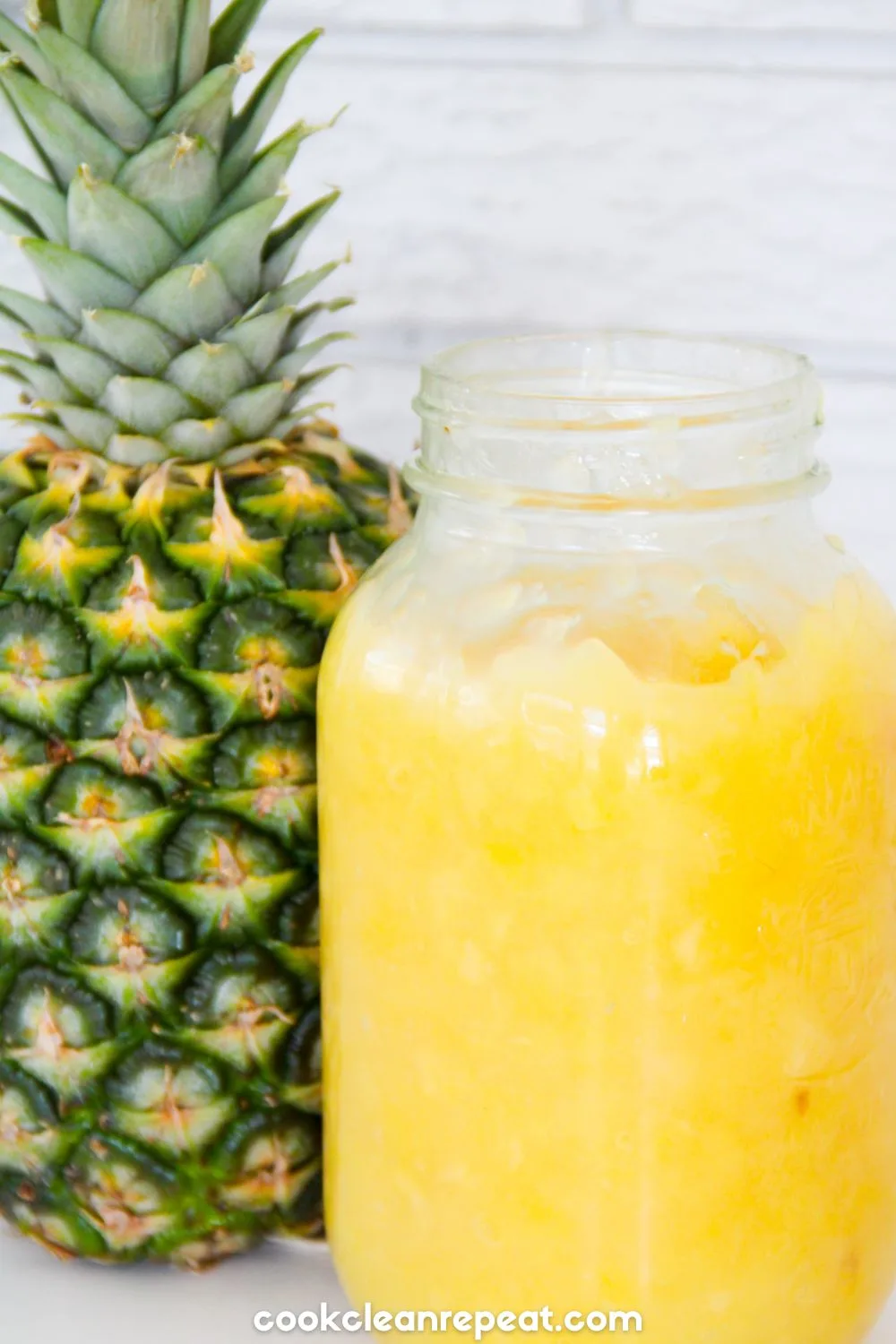 pineapple pie filling in a mason jar beside a pineapple