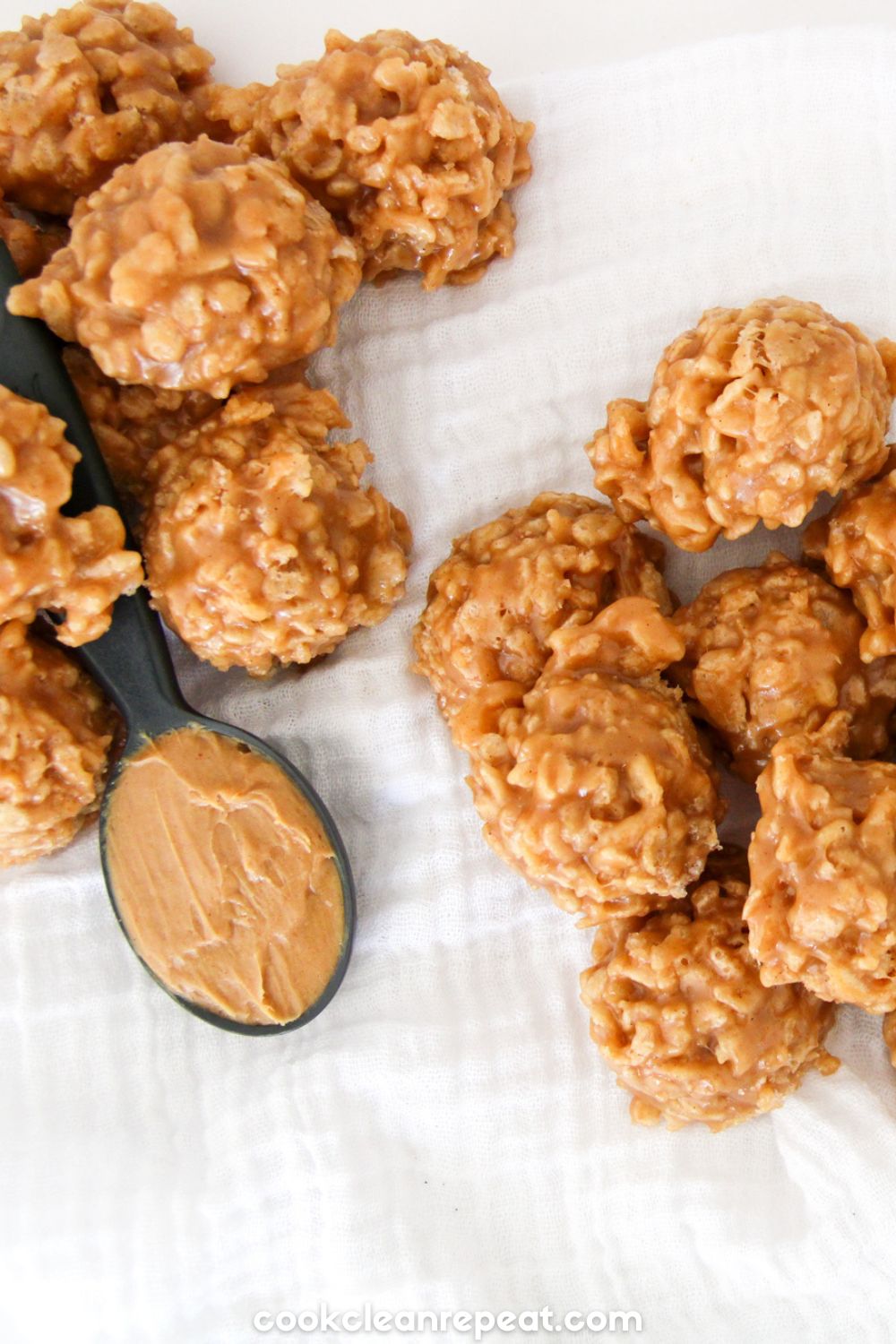 Rice Krispie cookies next to a spoon of peanut butter