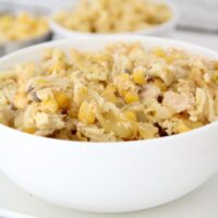 Tuna Casserole Recipe styled in a white bowl with two bowls in the background