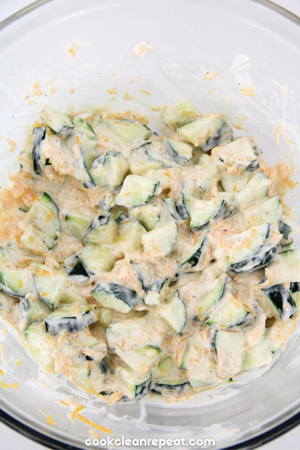 ingredients for this zucchini casserole recipe being mixed together in a bowl