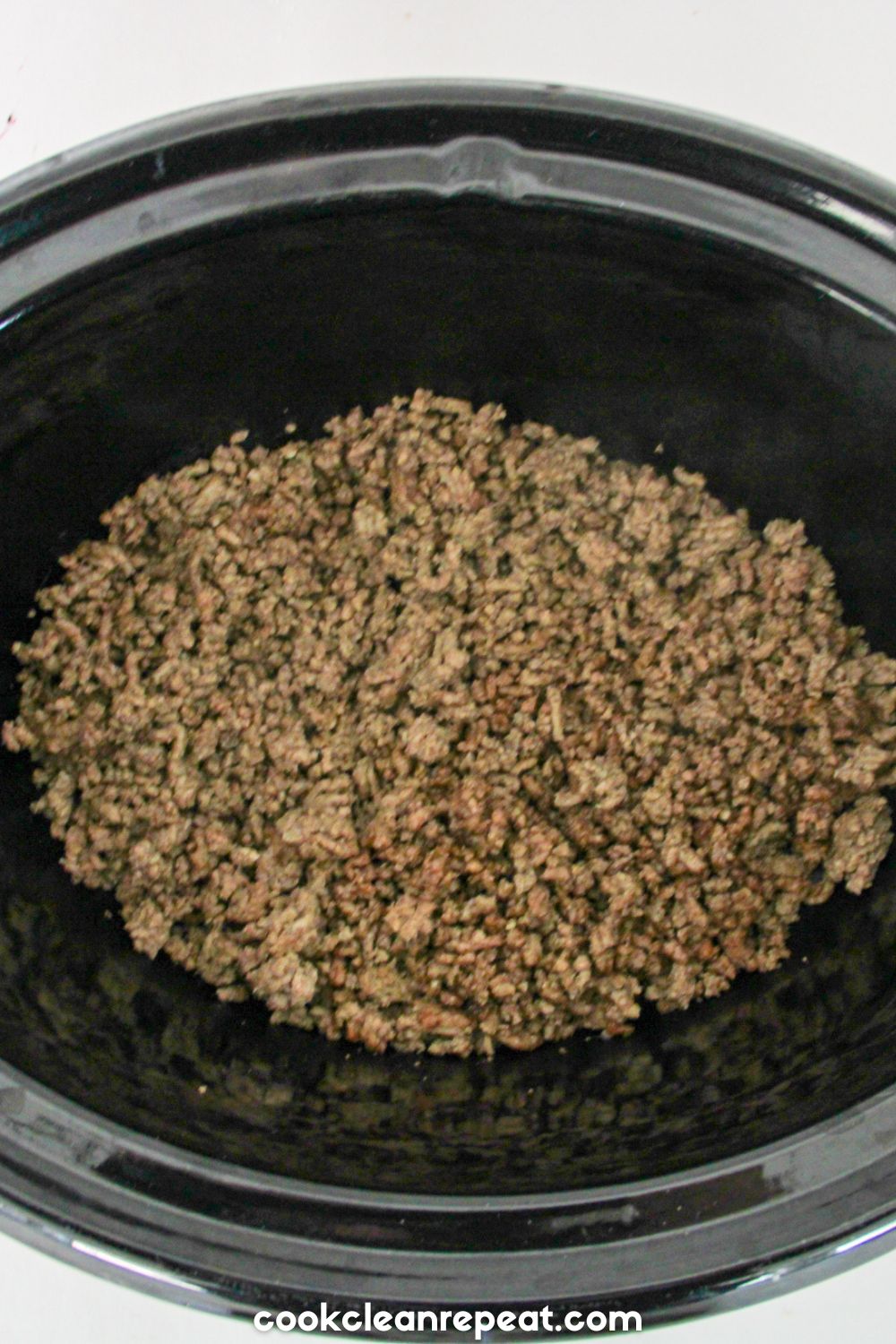 ground beef being browned in a crockpot