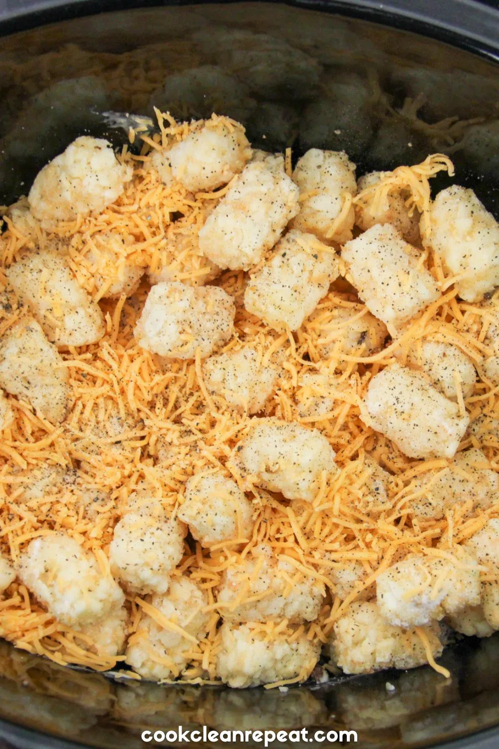 tater tots and shredded cheese added to crockpot