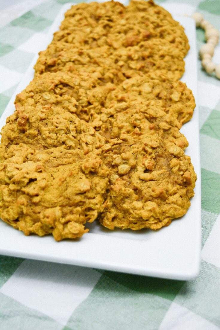 a close up image of a plate of Pumpkin Oatmeal Drop Cookies on a green checkered background