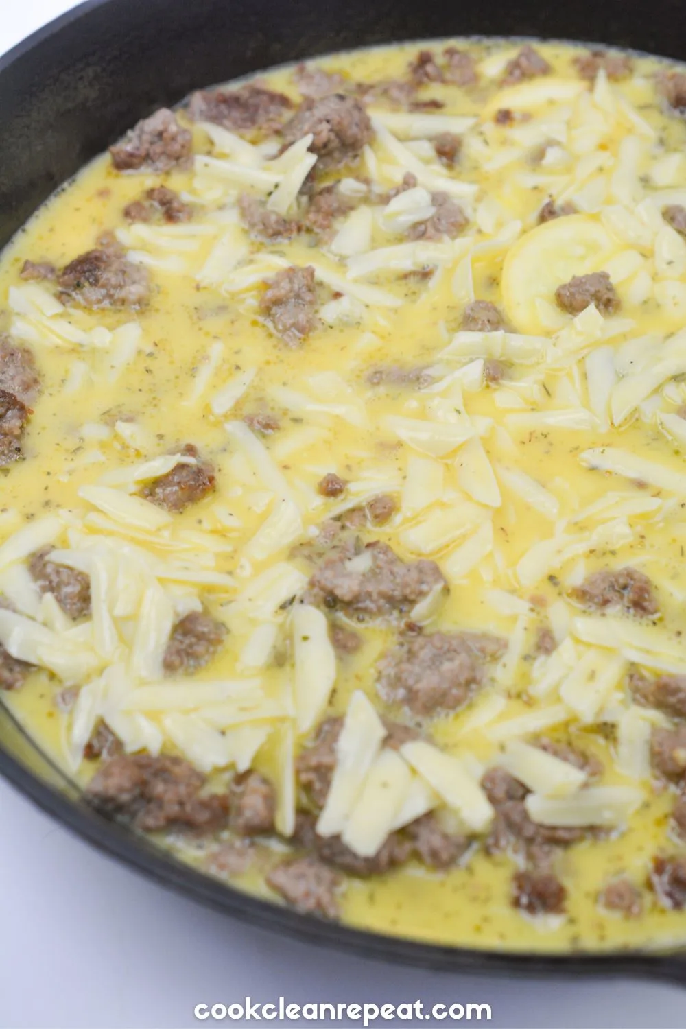 yellow squash cooking with meat and eggs