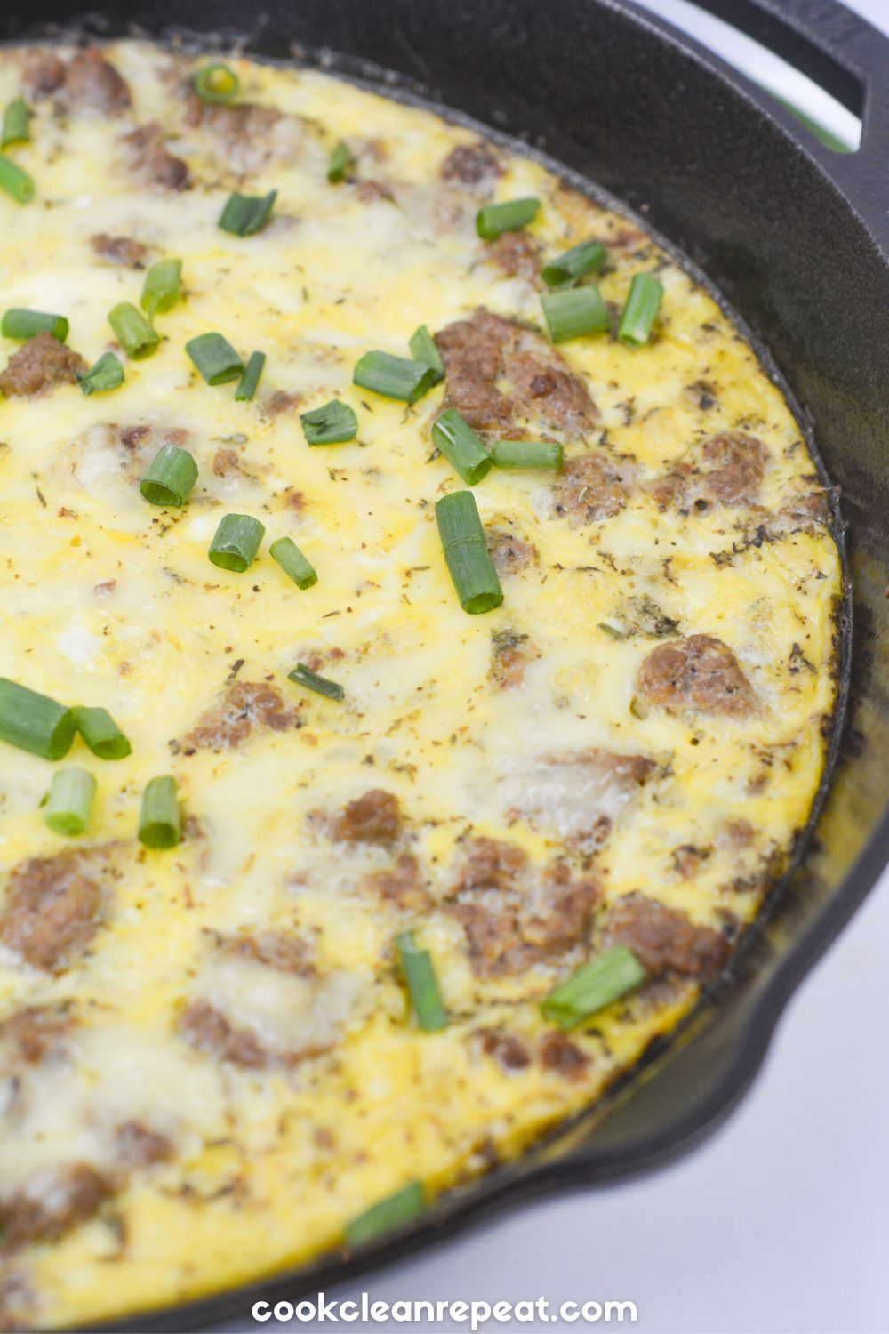 yellow squash quiche cooking with meat in a skillet