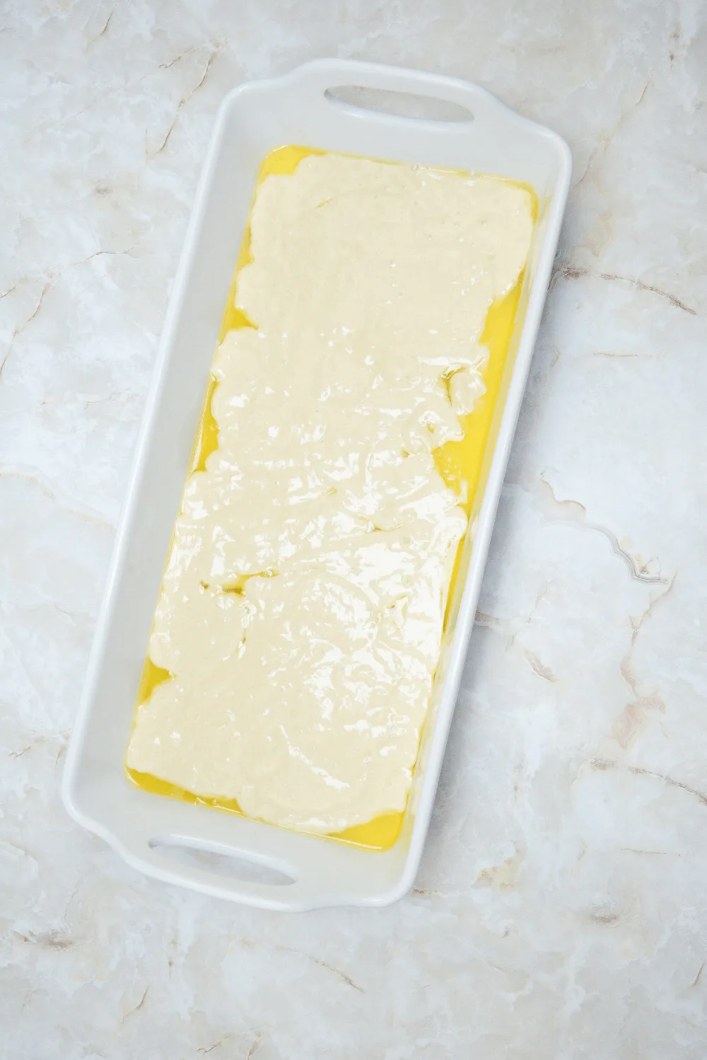 melted butter in pan for making pumpkin cobbler recipe