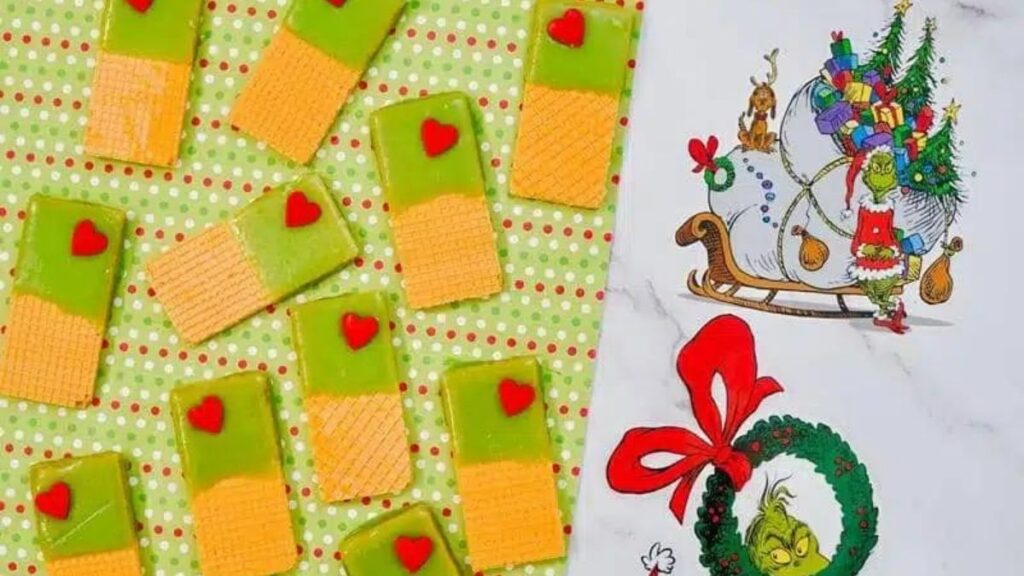 Sugar wafers dipped in green candy with a Grinchy red heart.