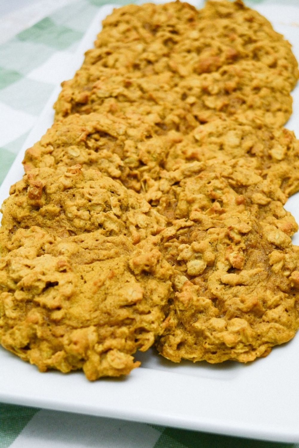 Pumpkin Oatmeal Drop Cookies on a white plate with a green and white checkered background